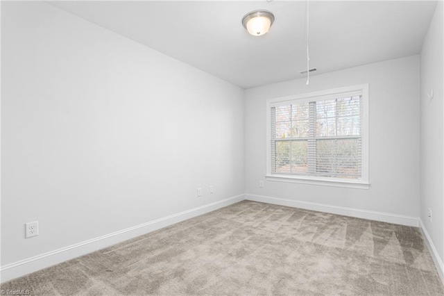 unfurnished room featuring light colored carpet