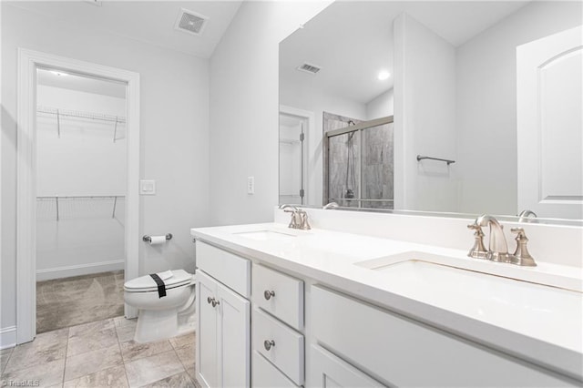 bathroom featuring vanity, toilet, and an enclosed shower