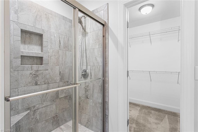 bathroom with a shower with door