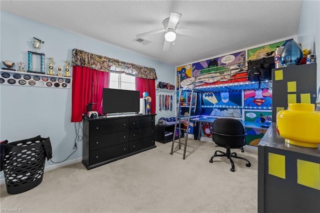 interior space featuring a ceiling fan, visible vents, and a textured ceiling