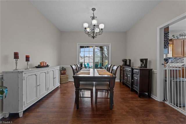 dining room with a notable chandelier, dark wood finished floors, and baseboards