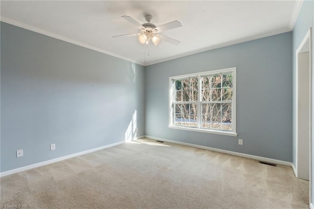 unfurnished room featuring light carpet, a ceiling fan, visible vents, baseboards, and ornamental molding