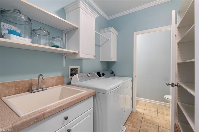 laundry room featuring cabinet space, light tile patterned floors, crown molding, separate washer and dryer, and a sink