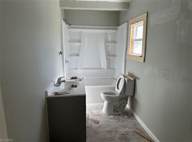 bathroom with baseboards, shower / tub combination, toilet, and a sink