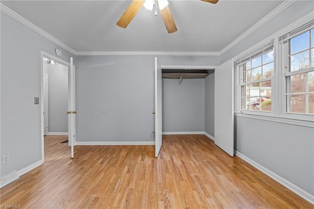 unfurnished bedroom with light wood-style floors, ornamental molding, and a closet