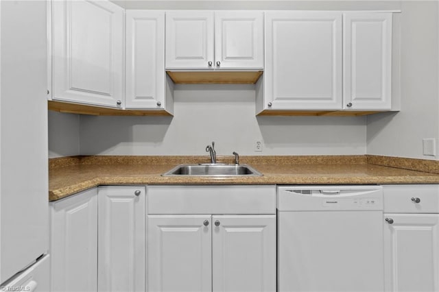 kitchen with white cabinetry, white dishwasher, and a sink