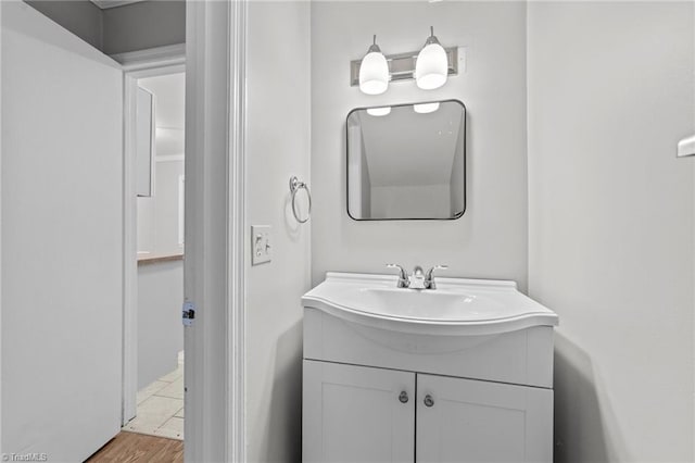 bathroom with wood finished floors and vanity