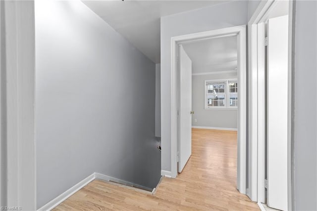 hallway with baseboards and light wood-style floors