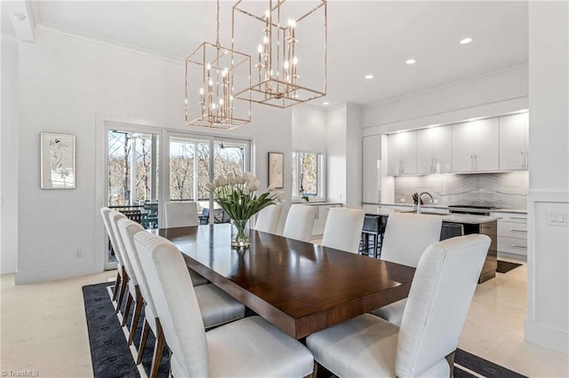 dining space featuring ornamental molding and sink