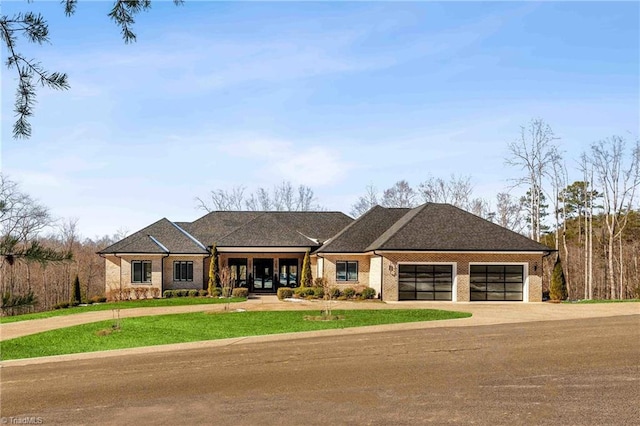 view of front of property with a garage and a front lawn