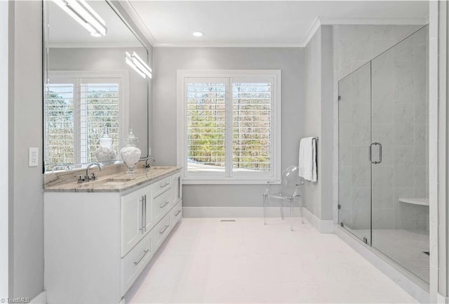 bathroom featuring vanity, ornamental molding, and walk in shower