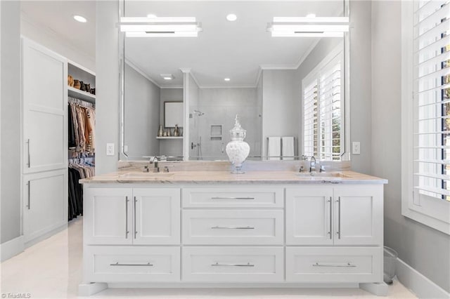 bathroom with walk in shower, vanity, and crown molding