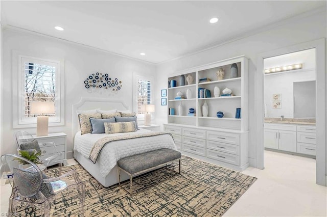 bedroom with multiple windows, ensuite bathroom, and crown molding