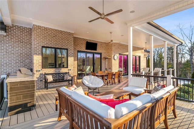 deck featuring ceiling fan and an outdoor hangout area