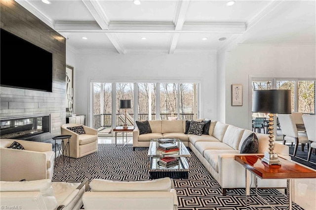 living room with crown molding, beam ceiling, a tiled fireplace, and coffered ceiling