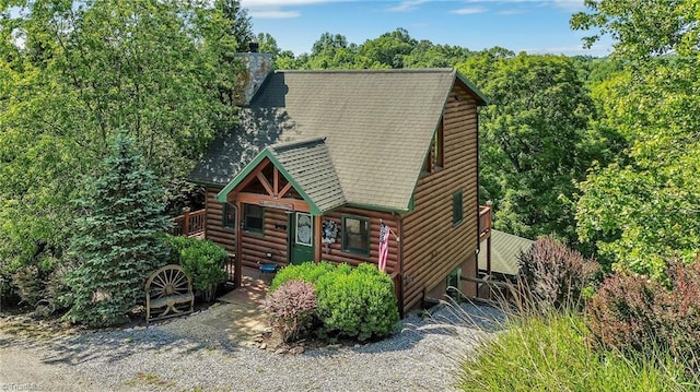 240 Deer Knoll Dr, Piney Creek, NC 28663 - log home with faux log siding, a chimney, and roof with shingles
