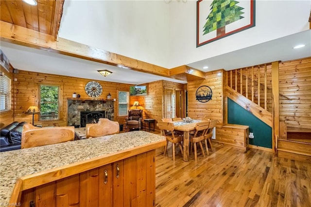 240 Deer Knoll Dr, Piney Creek, NC 28663 - kitchen with light wood-style floors, wooden walls, a fireplace, recessed lighting, and open floor plan