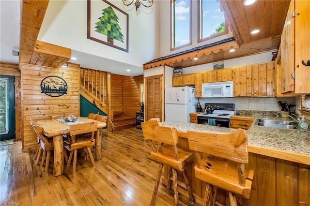 240 Deer Knoll Dr, Piney Creek, NC 28663 - kitchen with white appliances, plenty of natural light, light wood finished floors, light countertops, and a towering ceiling