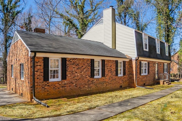 view of home's exterior with brick siding, a lawn, a chimney, and a shingled roof