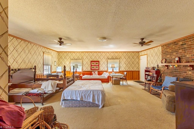 carpeted bedroom featuring multiple windows, a textured ceiling, ornamental molding, and wallpapered walls