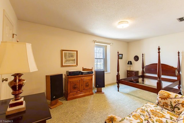 carpeted bedroom with baseboards, visible vents, and a textured ceiling