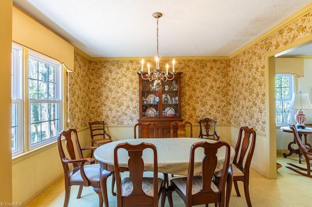 dining room featuring wallpapered walls, a wainscoted wall, a wealth of natural light, and a chandelier