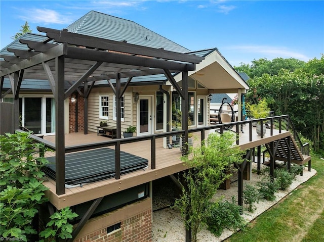 rear view of house featuring a pergola and a wooden deck