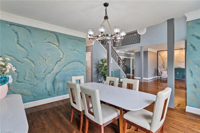 dining room with dark hardwood / wood-style floors, a notable chandelier, and ornamental molding