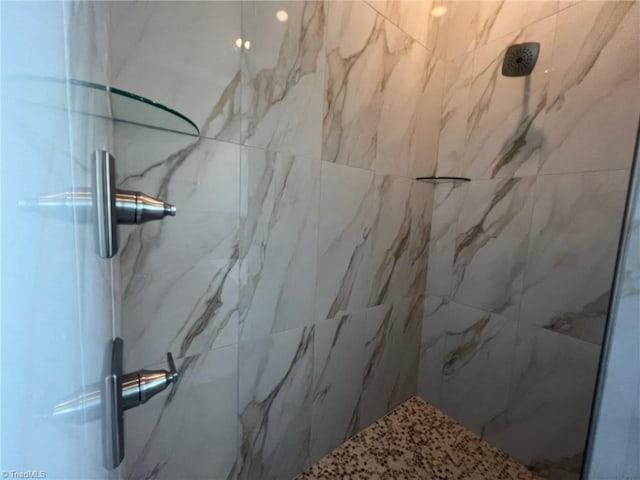 bathroom featuring a shower with door