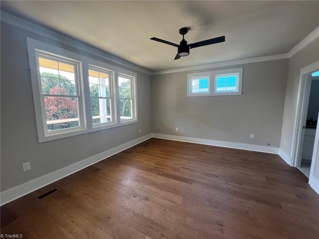 unfurnished room featuring ceiling fan, crown molding, and dark wood-type flooring