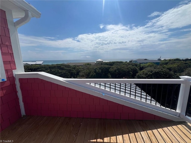 wooden terrace featuring a water view