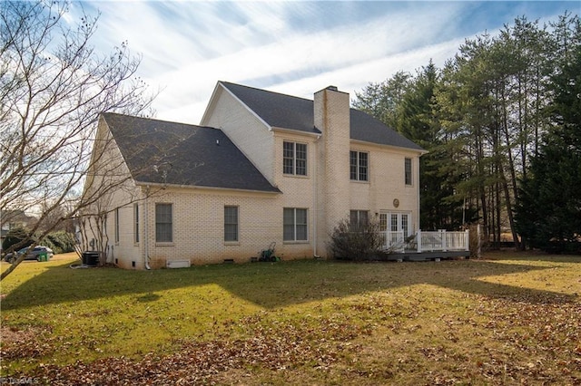 back of property with a deck, a lawn, and central air condition unit