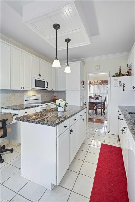 kitchen with a center island, white cabinets, white appliances, and decorative light fixtures