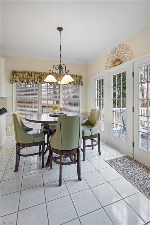 tiled dining room featuring crown molding and a chandelier