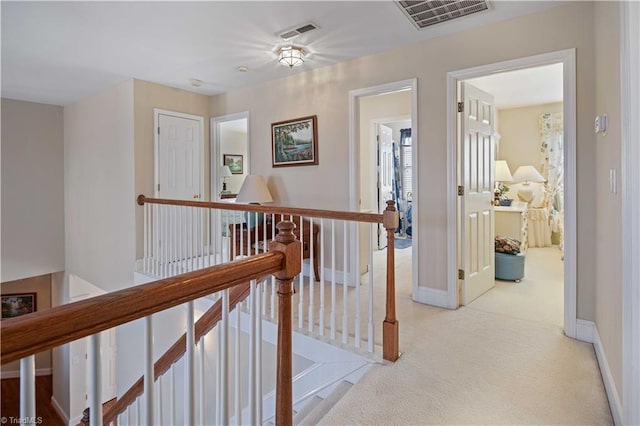 hallway with light colored carpet