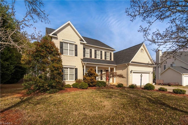 view of front of property with a garage and a front yard