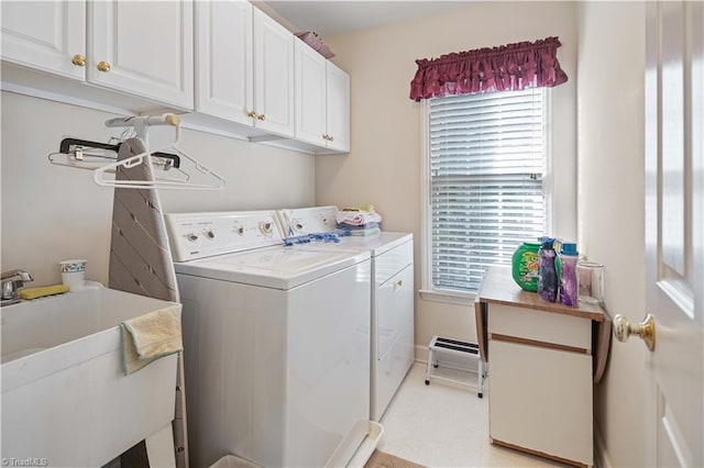 laundry area with cabinets, sink, and washing machine and clothes dryer