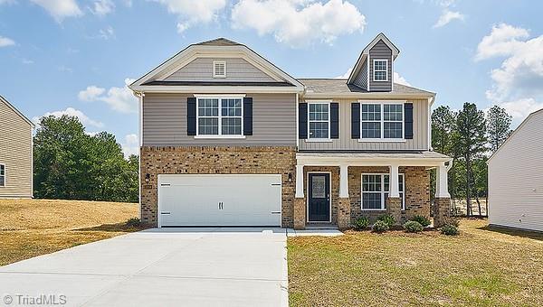 craftsman-style home with a front lawn and a garage