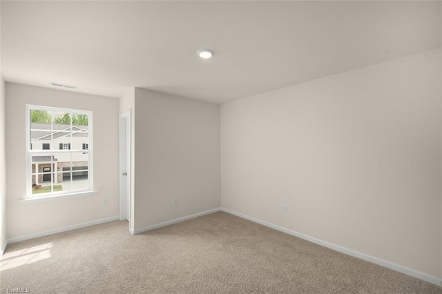 unfurnished room with light colored carpet