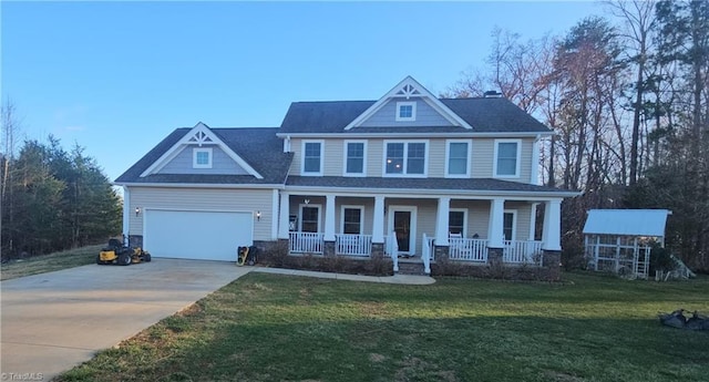 view of front facade with covered porch, a front lawn, concrete driveway, and a garage