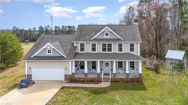 view of front facade featuring a front yard, covered porch, concrete driveway, a garage, and stone siding