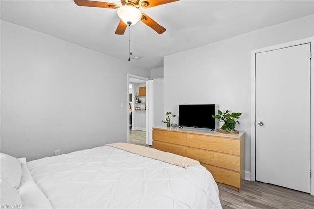 bedroom with ceiling fan and wood-type flooring