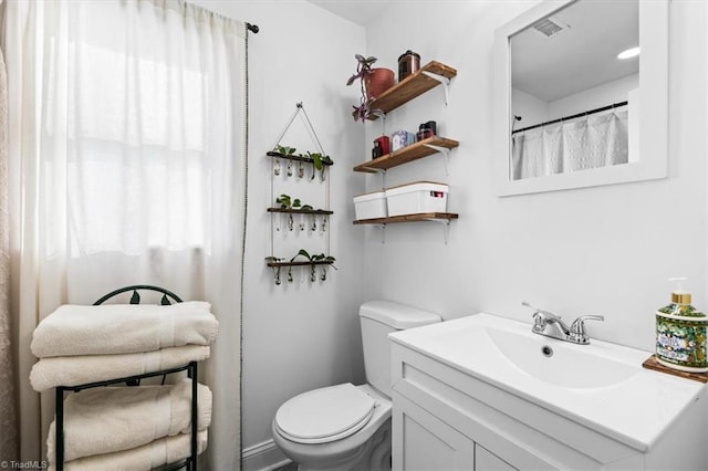 bathroom with vanity and toilet