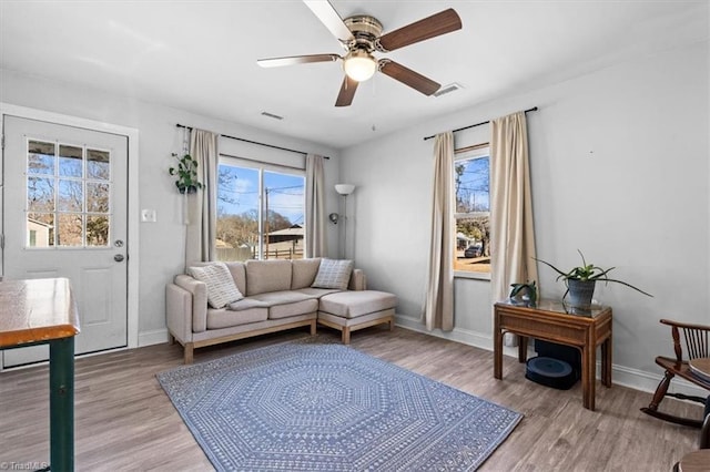 living room featuring ceiling fan and light wood-type flooring