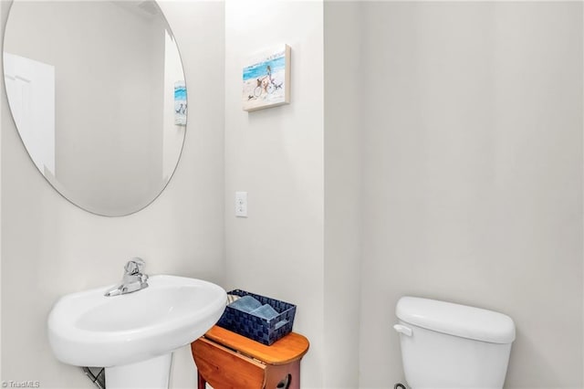 bathroom with toilet and a sink