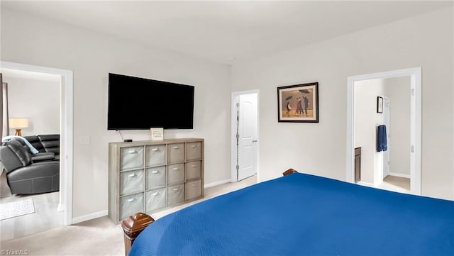 carpeted bedroom featuring baseboards