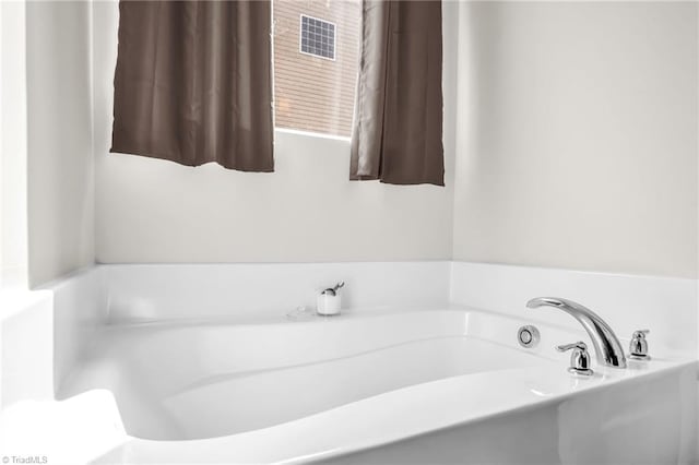 full bath featuring a garden tub and visible vents