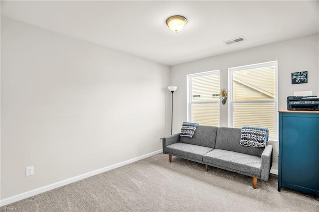 sitting room with carpet floors, baseboards, and visible vents