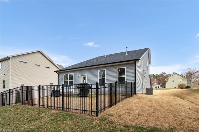 back of property featuring a lawn, fence, and central air condition unit