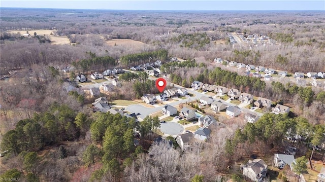 birds eye view of property featuring a forest view and a residential view